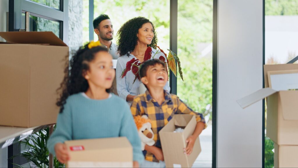Family with children unpacking boxes in a new home