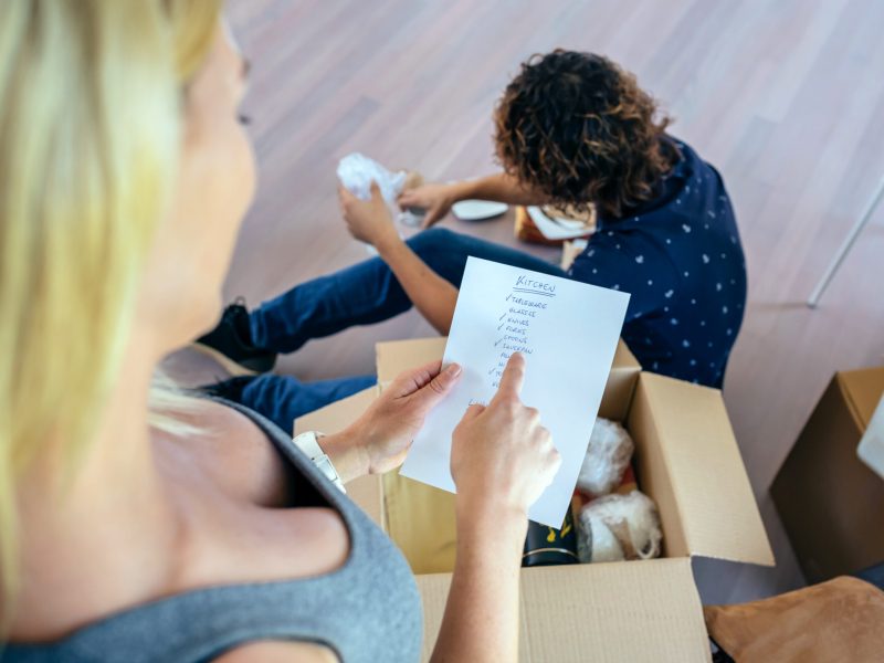 Couple unpacking moving boxes in their new house